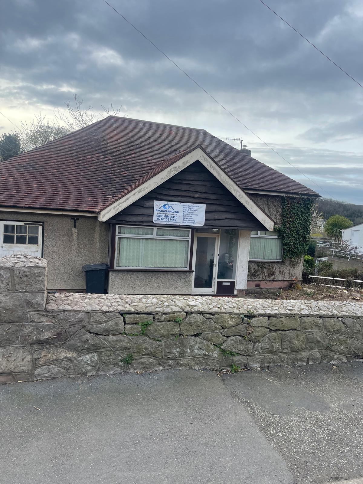 Bungalow property with Anglian Building & Roofing signage