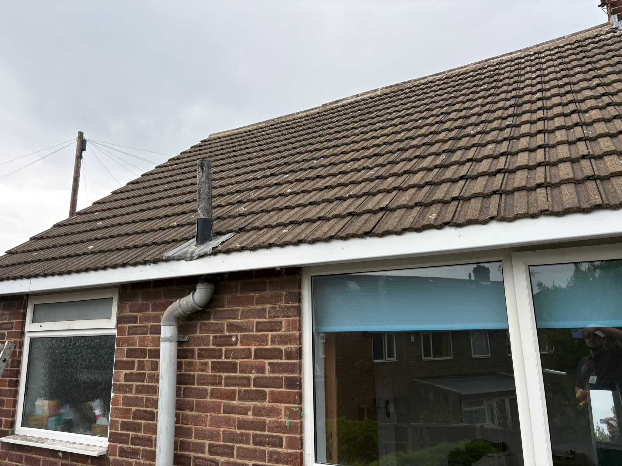 Brick bungalow rear view showing completed roof tiles