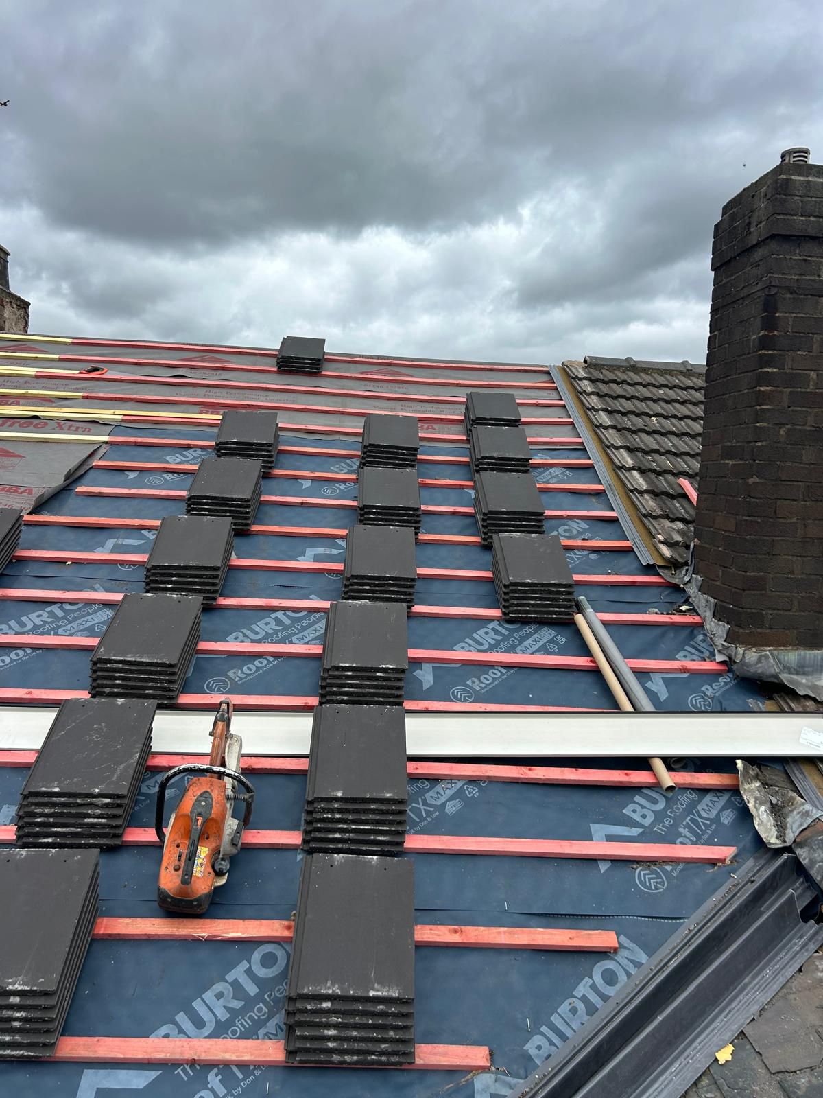 Close-up of aged roof tiles with ladder during survey