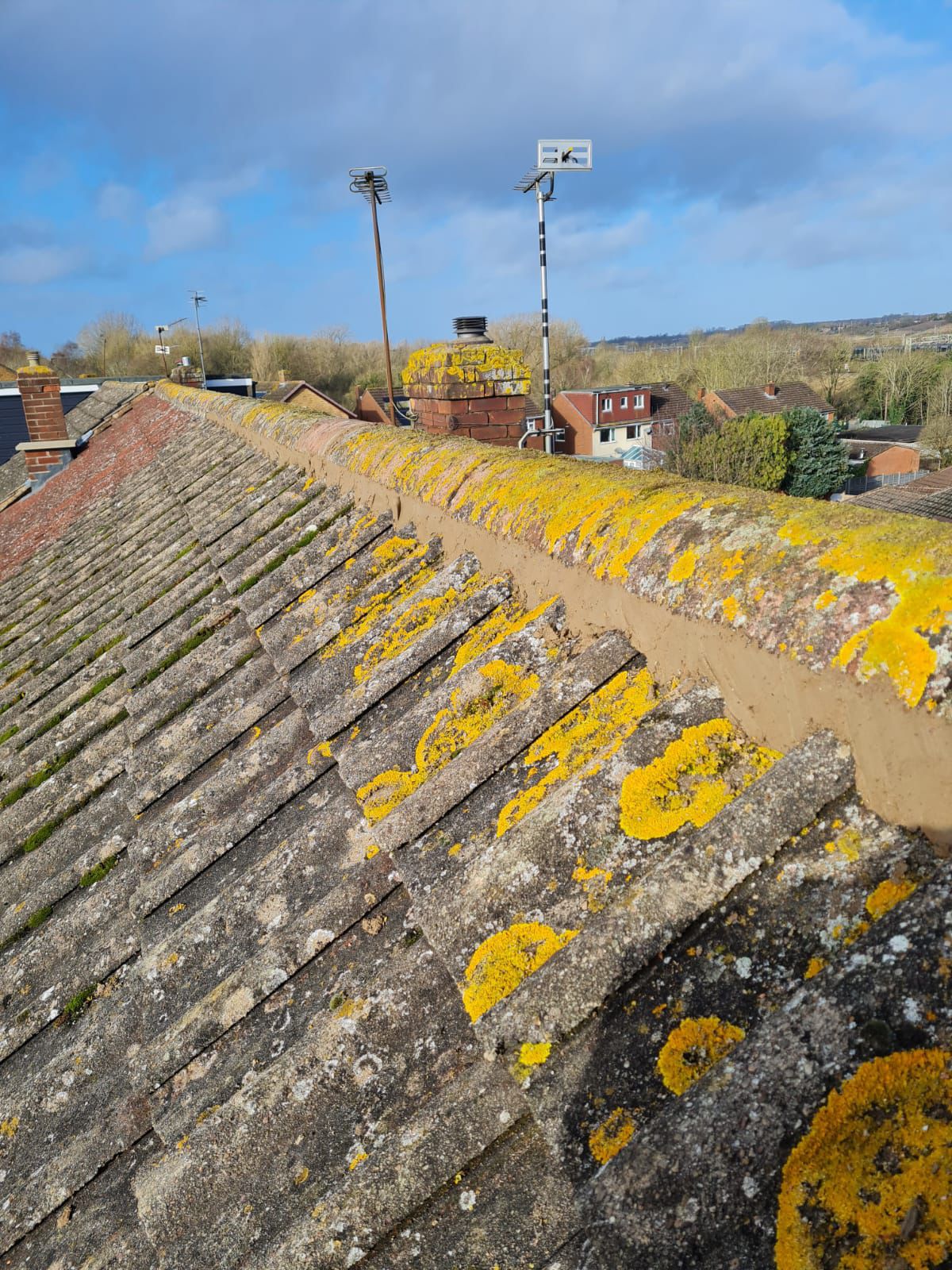 Pitched roof repair with new ridge tiles