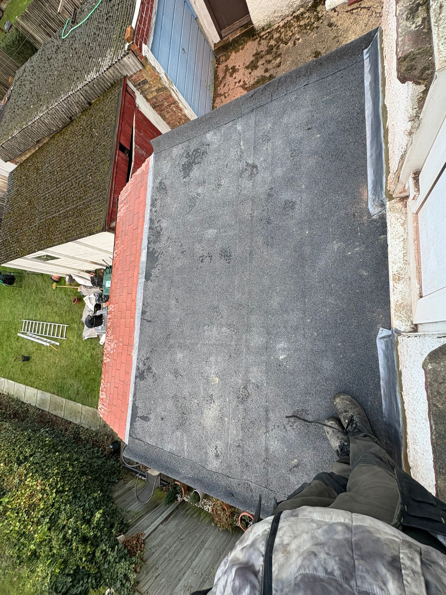 Completed flat roof felt installation on extension
